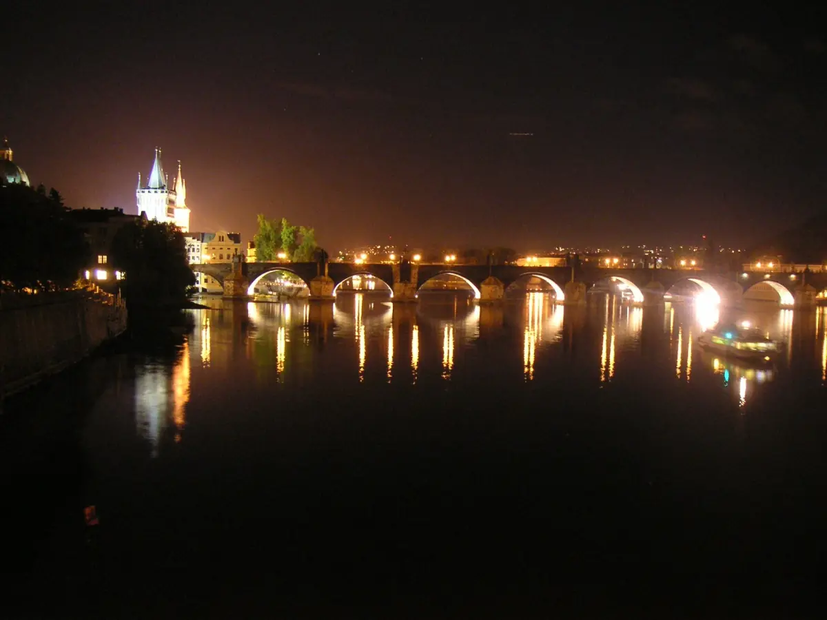 Charles Bridge reflected in the river at night