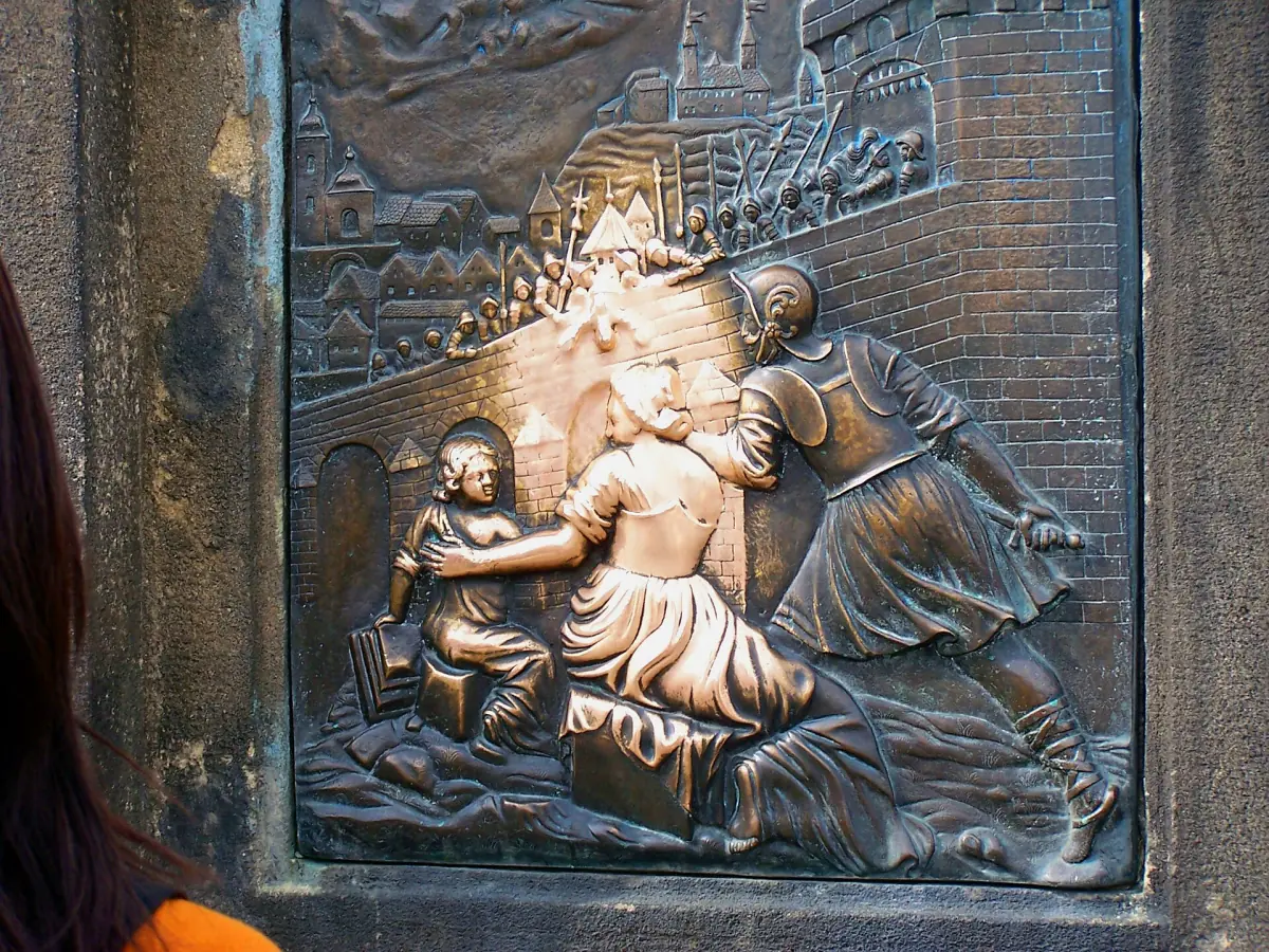 The bronze relief below the Nepomuk statue